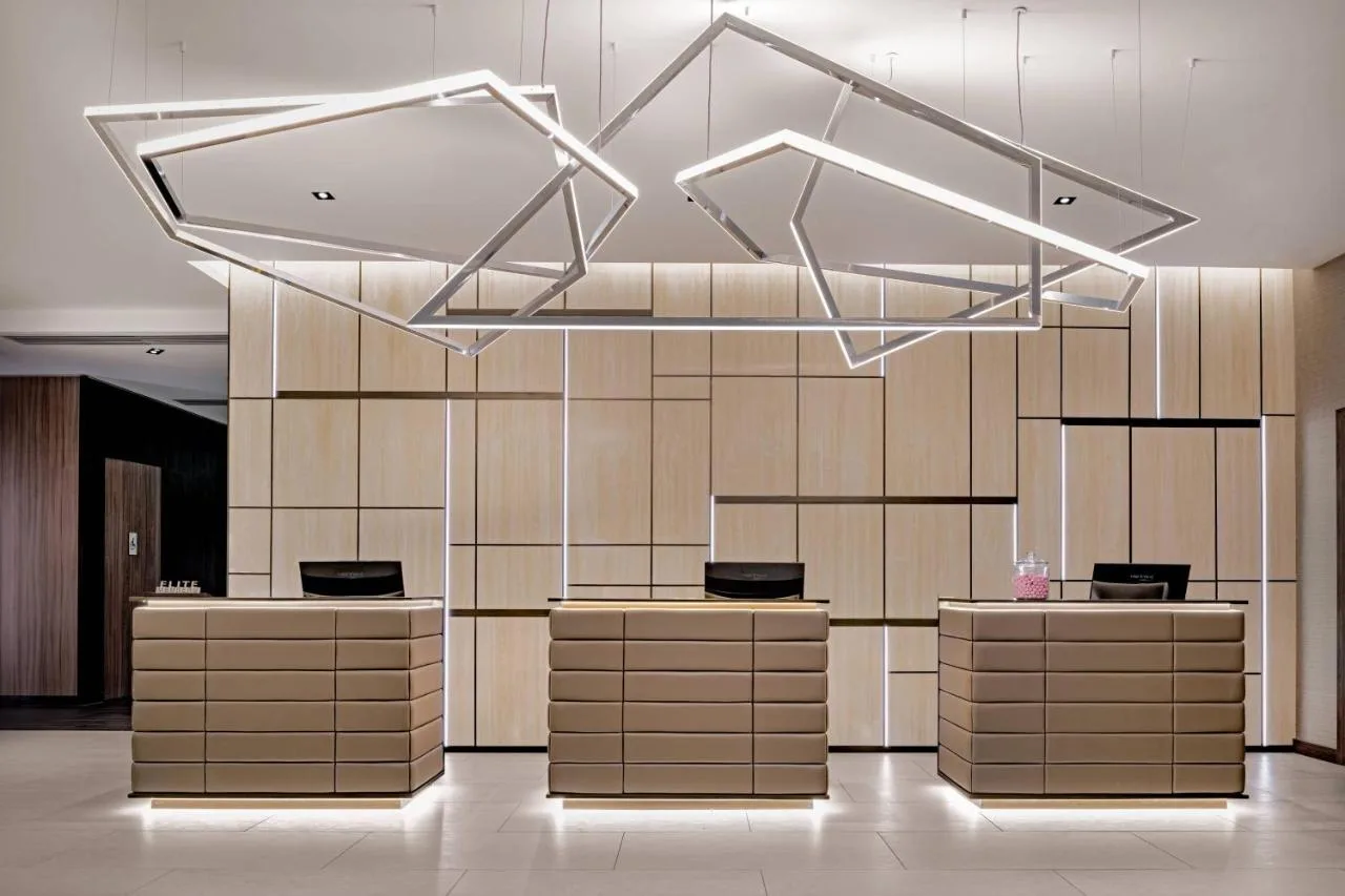 a lobby with a row of counters in a building at AC Hotel by Marriott Manchester City Centre in Manchester